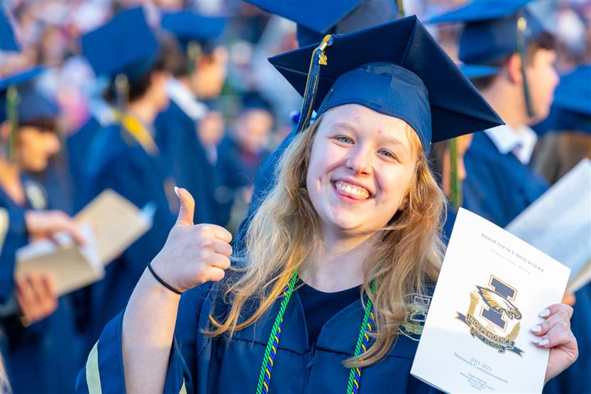 Students wearing blue graduation robes